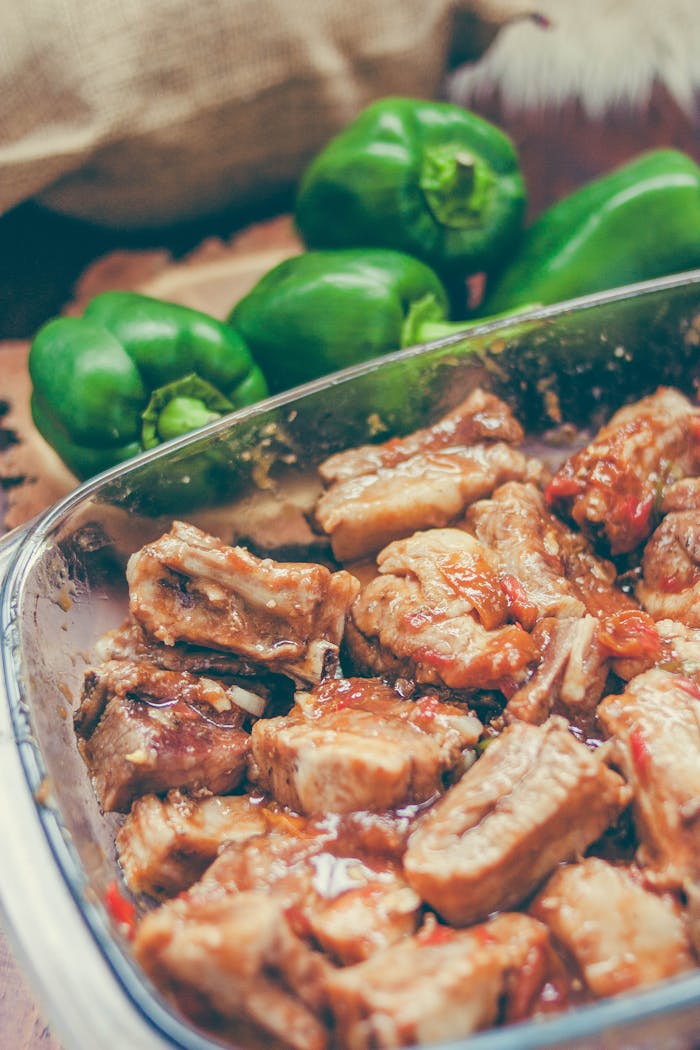 Mouth-watering pork ribs with roasted green peppers, perfect for a hearty meal.